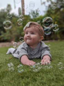 baby playing with bubbles